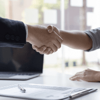 Two men shaking hands after receiving a job offer 